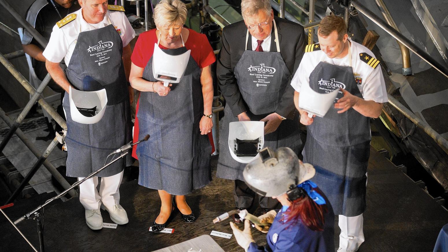 Heather Johnson prepares to weld the initials of ship's sponsor Diane Donald on a metal plate during the keel laying ceremony for the future Virginia-class attack submarine Indiana (SSN 789).